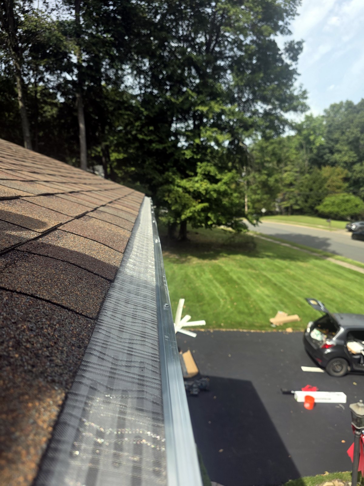 After gutter guard installation: stainless-steel micro-mesh fitted to the same roofline