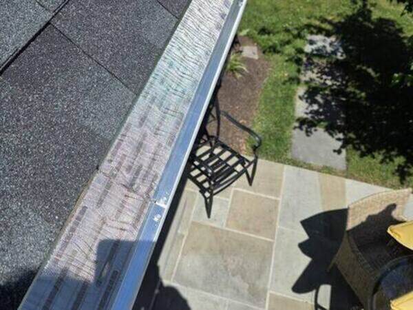Micro mesh gutter guard installed along roof eave above patio